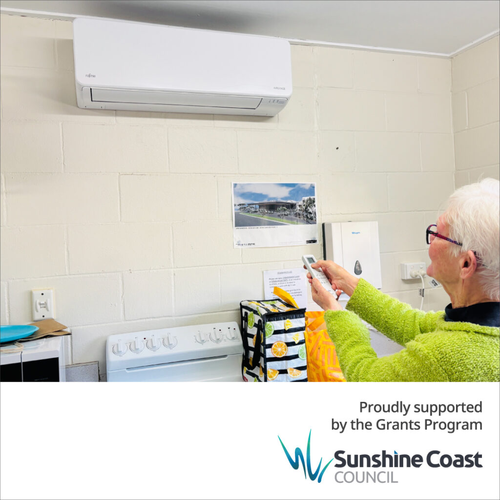 A member of Caloundra Arts Centre Association turns on the new airconditioning unit, installed thanks to a Sunshine Coast Council grant.